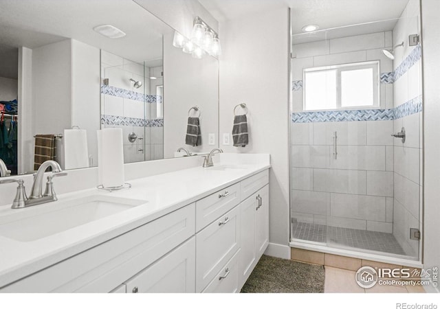 bathroom with tile patterned floors, vanity, and an enclosed shower