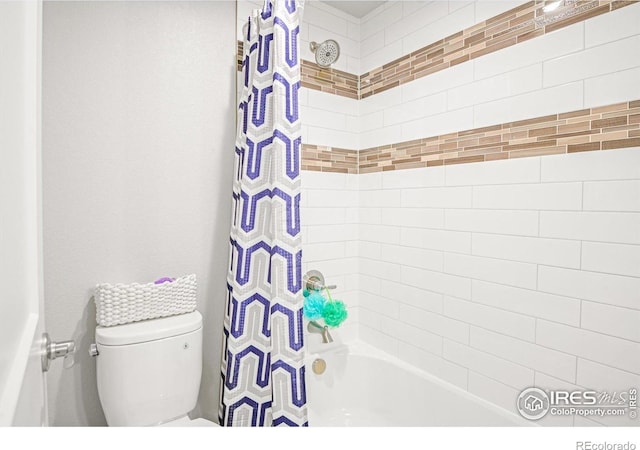 bathroom with shower / bath combination with curtain and toilet