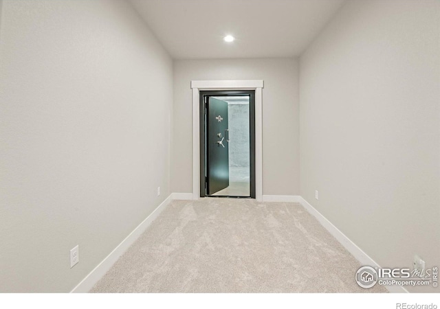 unfurnished room featuring light colored carpet