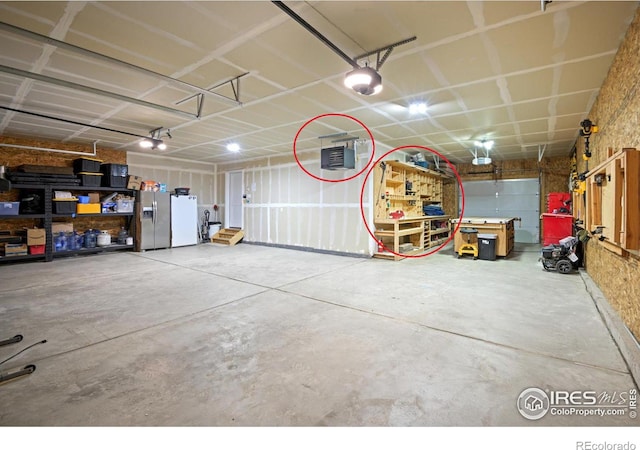 garage featuring stainless steel fridge with ice dispenser and a garage door opener