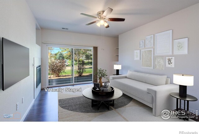 living room with ceiling fan and wood-type flooring