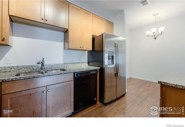 kitchen with pendant lighting, a chandelier, dishwasher, stainless steel refrigerator with ice dispenser, and hardwood / wood-style floors