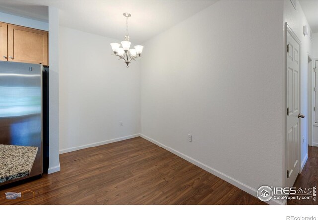 interior space with a notable chandelier and dark wood-type flooring