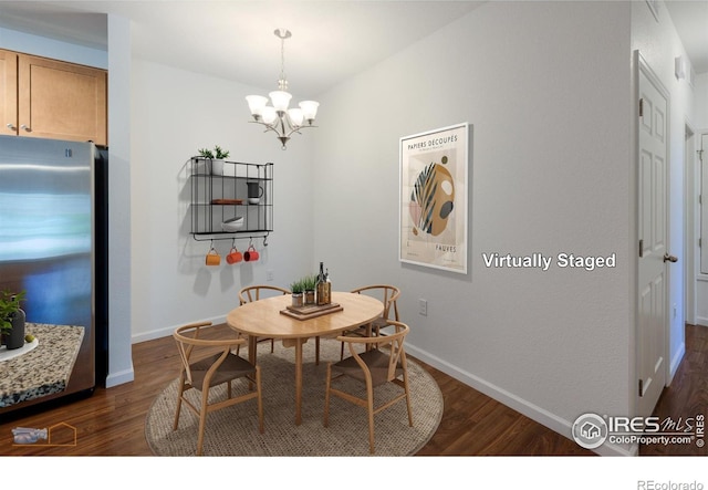 dining area featuring a notable chandelier and dark hardwood / wood-style flooring