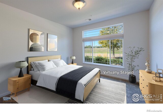 bedroom with dark colored carpet