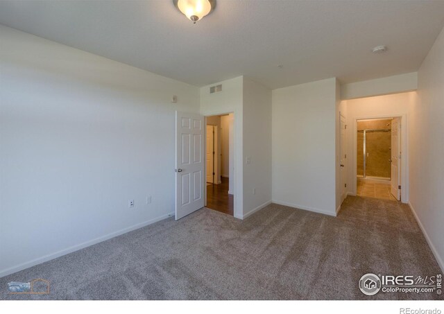 unfurnished bedroom with light colored carpet