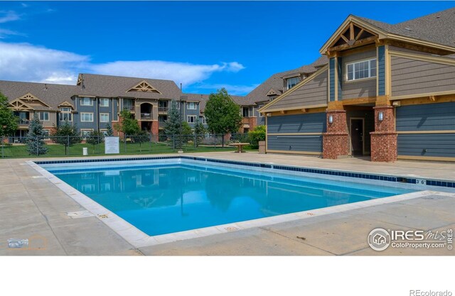 view of pool with a lawn