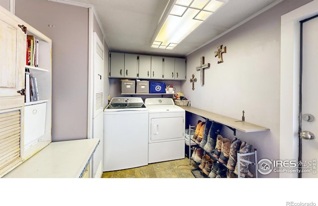 clothes washing area featuring cabinet space and washer and dryer