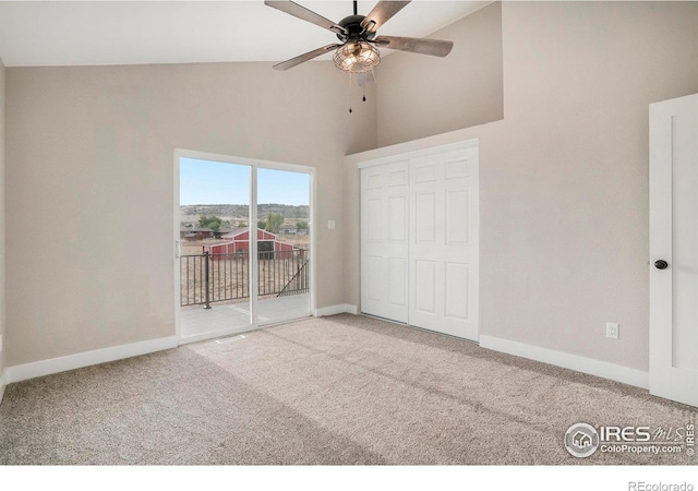 unfurnished bedroom featuring high vaulted ceiling, a closet, carpet flooring, ceiling fan, and access to outside