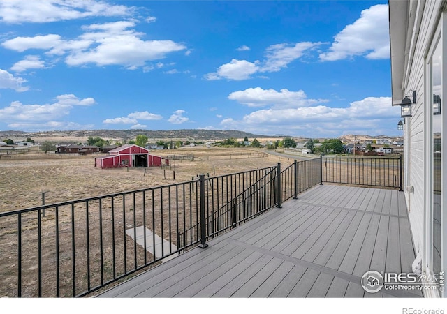 wooden deck featuring a storage unit and a mountain view