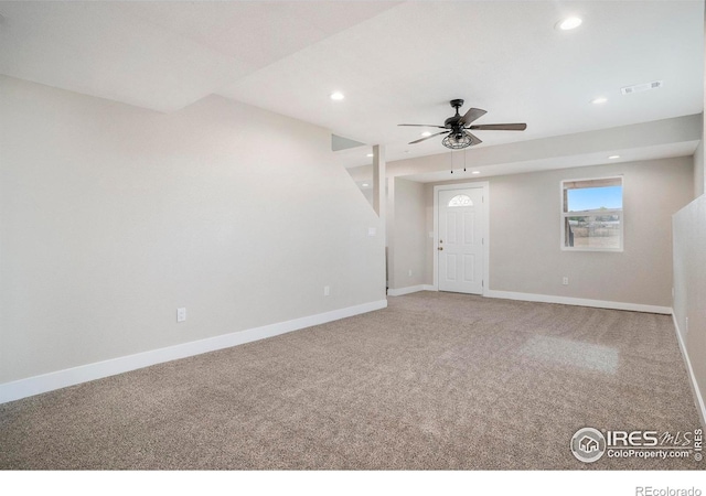 carpeted spare room featuring ceiling fan