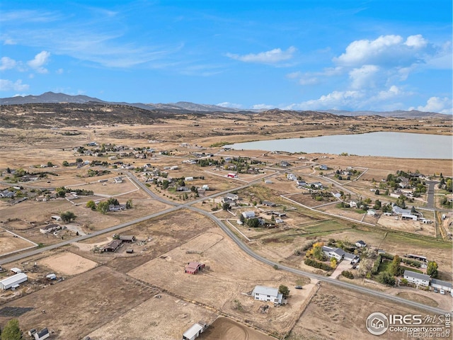 aerial view featuring a water and mountain view