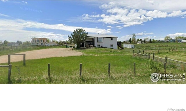 view of yard with a rural view