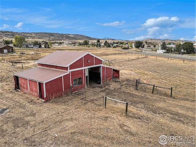 view of outbuilding with a mountain view and a rural view