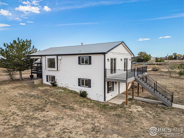 view of side of property featuring a wooden deck