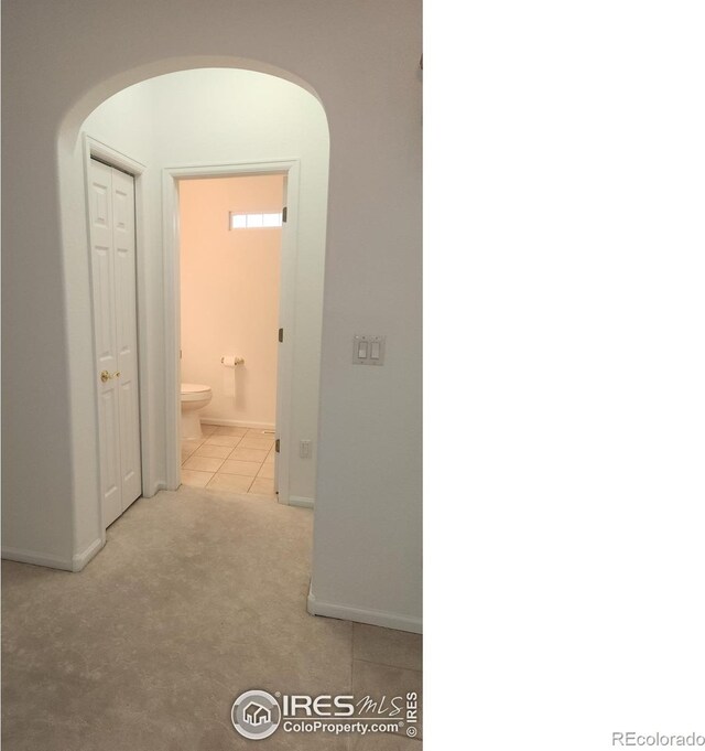 hallway with light tile patterned floors