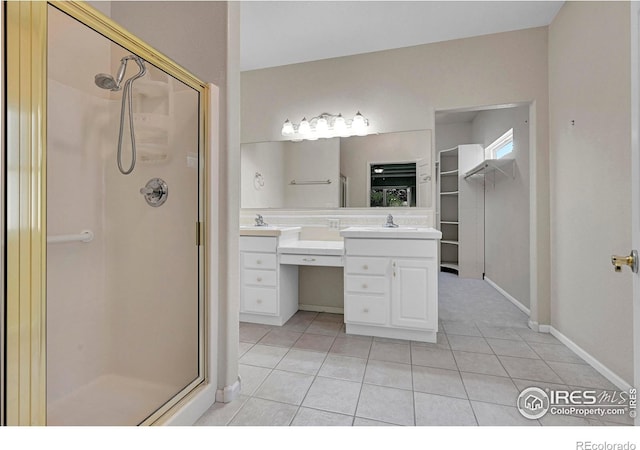 bathroom featuring vanity, tile patterned floors, and a shower with shower door