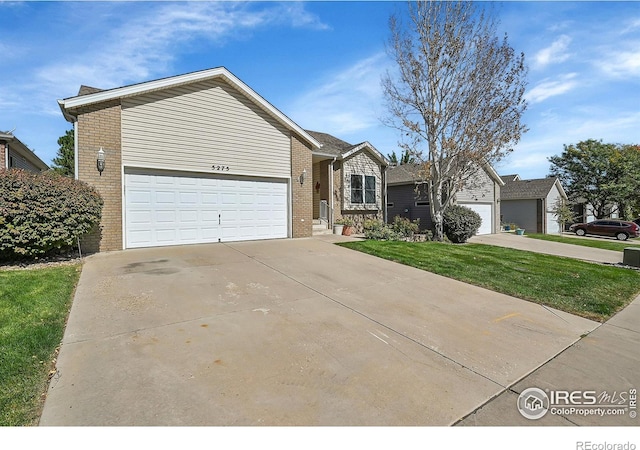 view of front facade with a garage and a front lawn