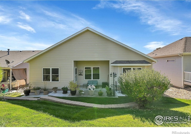 back of property featuring a patio and a yard