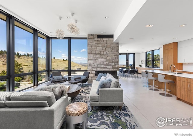 living room featuring a wall of windows and plenty of natural light