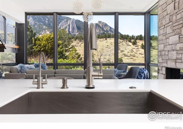 interior space featuring a mountain view, a fireplace, plenty of natural light, and sink