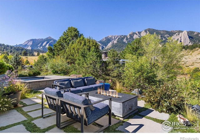 view of patio featuring a mountain view and an outdoor living space