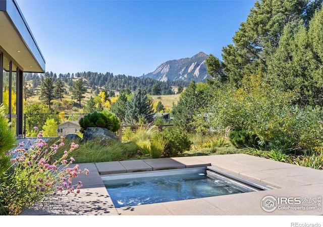 view of swimming pool featuring a mountain view