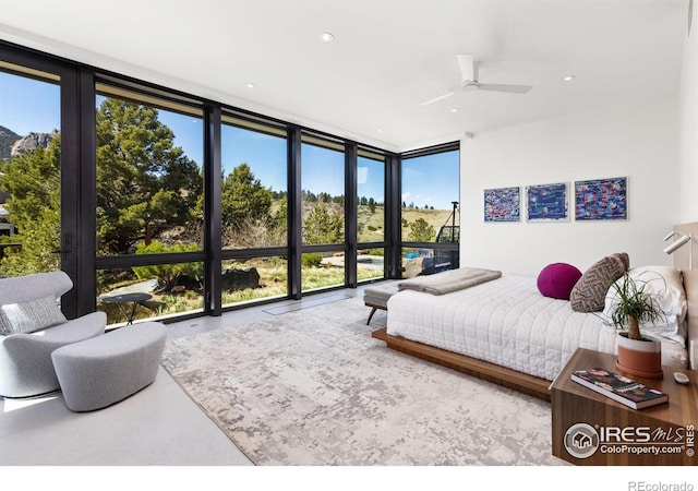 bedroom with floor to ceiling windows and ceiling fan