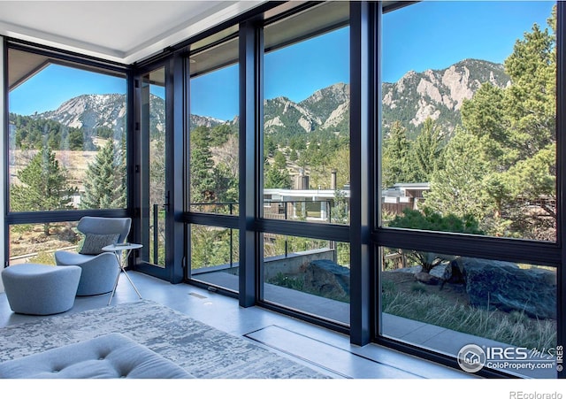 sunroom with a mountain view and plenty of natural light