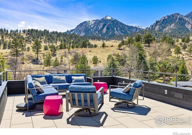 view of patio / terrace with a mountain view, a balcony, and an outdoor living space