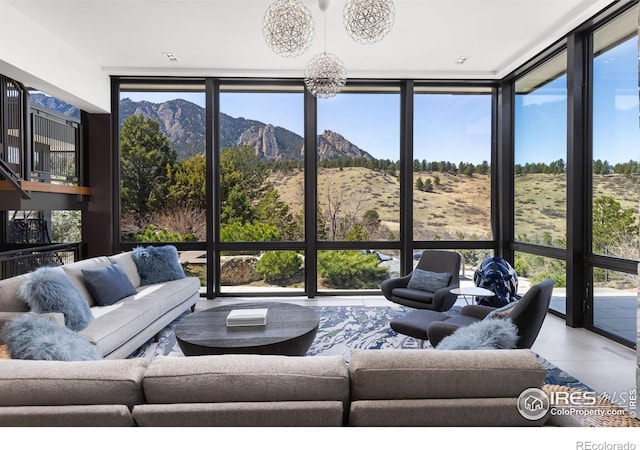 sunroom with a mountain view and a healthy amount of sunlight