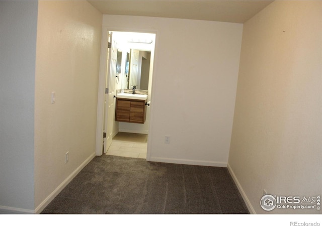 empty room with sink and light colored carpet