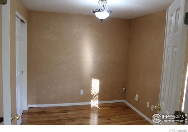 spare room with hardwood / wood-style flooring