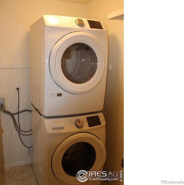 laundry area featuring stacked washing maching and dryer