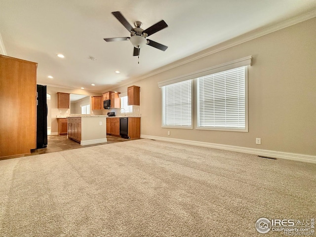 unfurnished living room featuring ornamental molding, light carpet, and ceiling fan