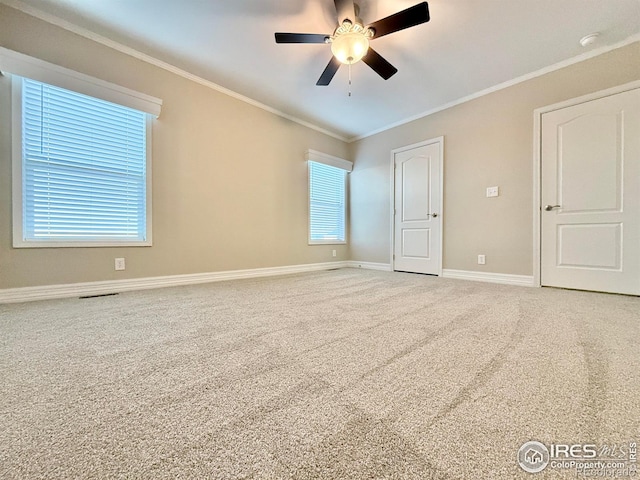 carpeted empty room with ornamental molding and ceiling fan