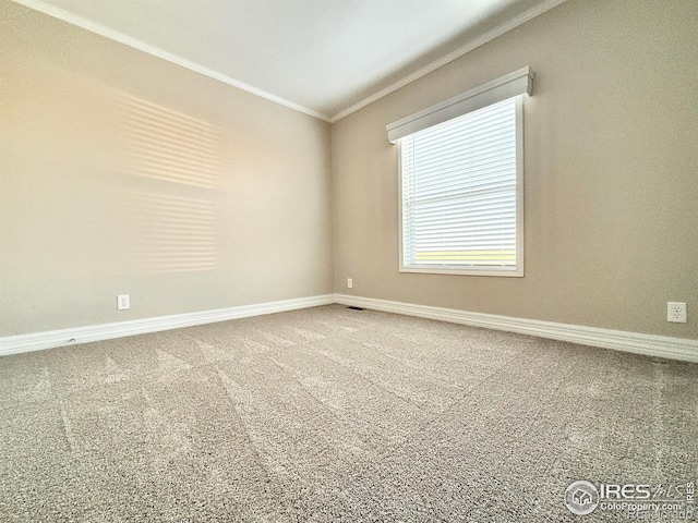 unfurnished room featuring baseboards, ornamental molding, visible vents, and carpet floors