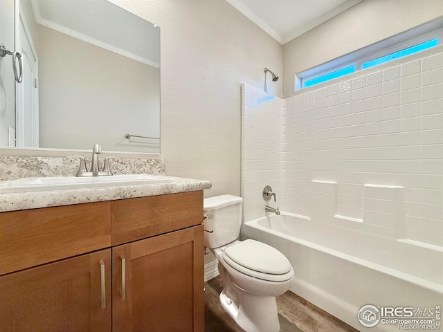 full bath featuring vanity, bathing tub / shower combination, crown molding, toilet, and wood finished floors