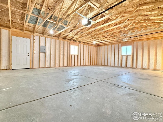 garage with electric panel and a garage door opener