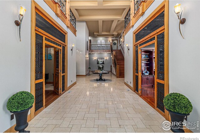 8532 Strawberry Ln, Niwot, CO 80503 - hall with baseboards, beam ceiling, stairs, and coffered ceiling