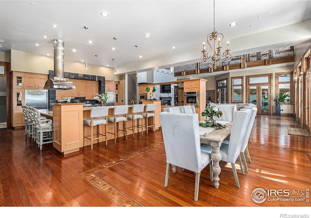 dining space featuring wood-type flooring and a chandelier