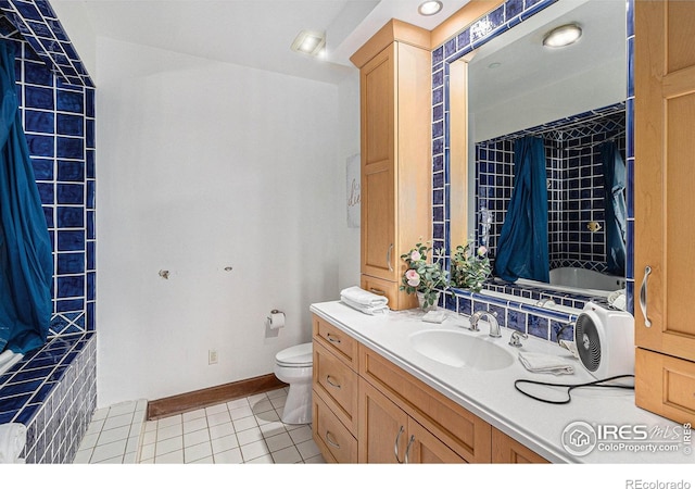 full bathroom featuring tile patterned flooring, vanity, toilet, and shower / bathtub combination with curtain