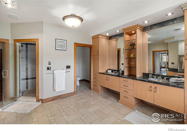 8532 Strawberry Ln, Niwot, CO 80503 - full bathroom featuring toilet, a stall shower, vanity, baseboards, and recessed lighting