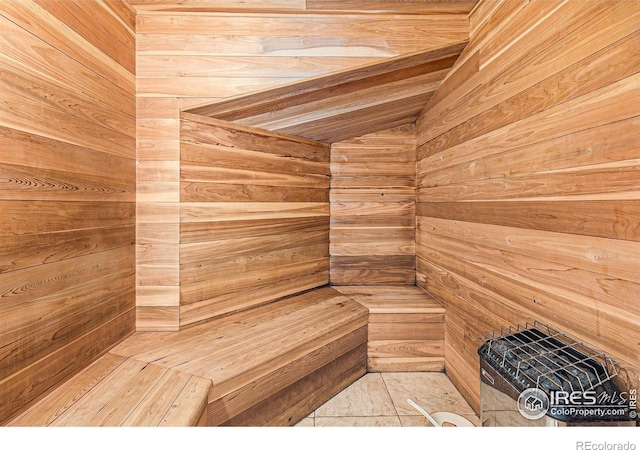 view of sauna featuring wooden walls and tile patterned flooring