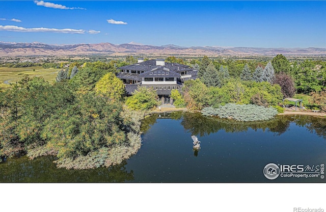 birds eye view of property featuring a water and mountain view