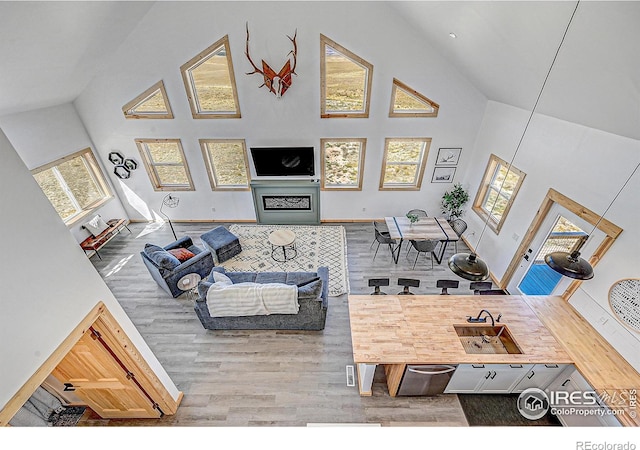 living room with high vaulted ceiling and a wealth of natural light