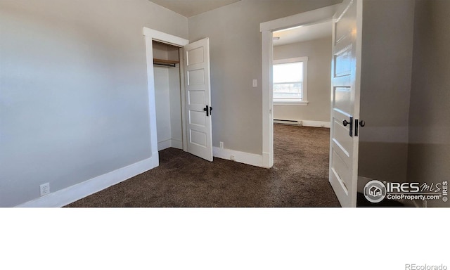 101-105 Factory St, Sterling, CO 80751 - unfurnished bedroom featuring carpet floors and a baseboard heating unit