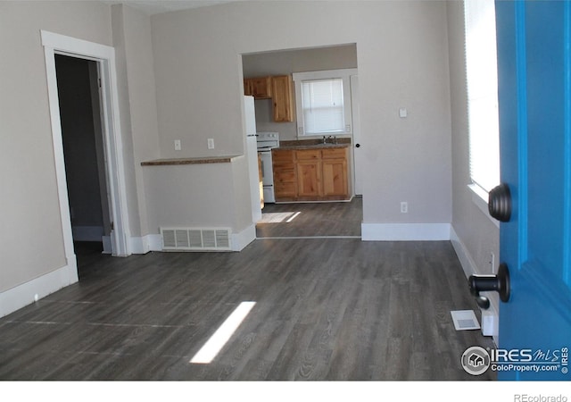 101-105 Factory St, Sterling, CO 80751 - unfurnished living room featuring healthy amount of natural light and dark wood-type flooring