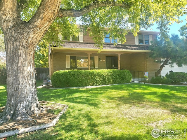 view of front of home with covered porch and a front yard