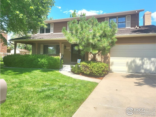 view of front of property featuring a front yard and a garage